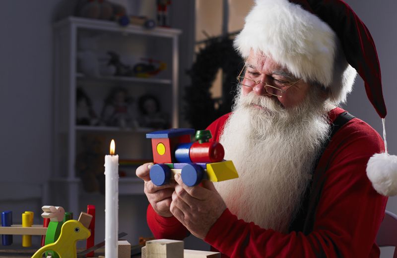 Santa working on a toy in his workshop