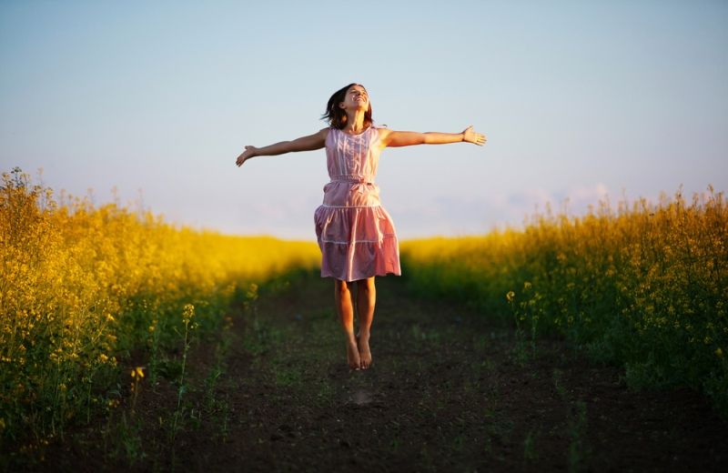 happy woman, jumping for joy - Shutterstock