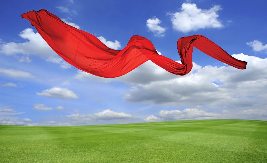 A long red scarf floats on the breeze.
