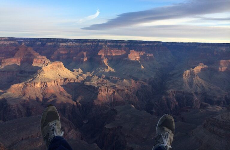 Adam Hunter's feet dangle over the Grand Canyon.