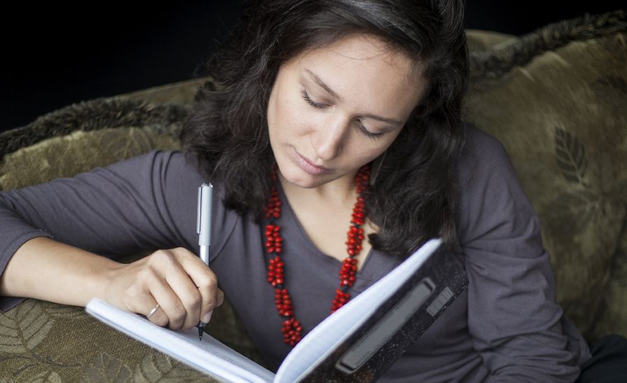 A woman writes in her journal.