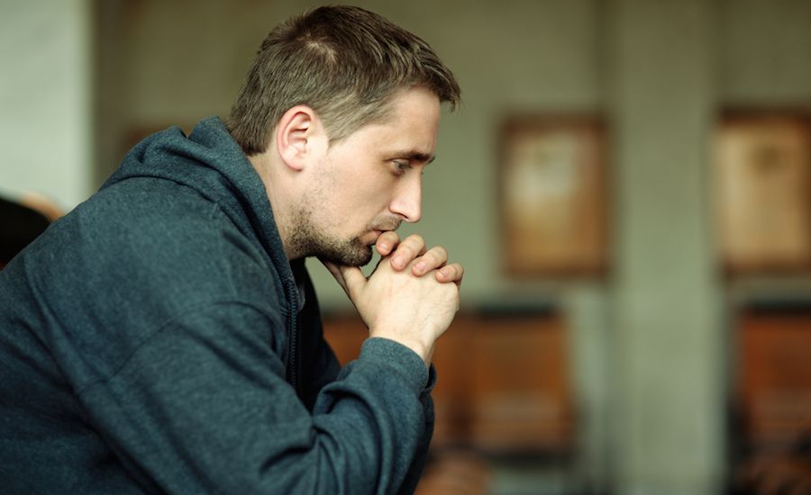 Man praying. Shutterstock.