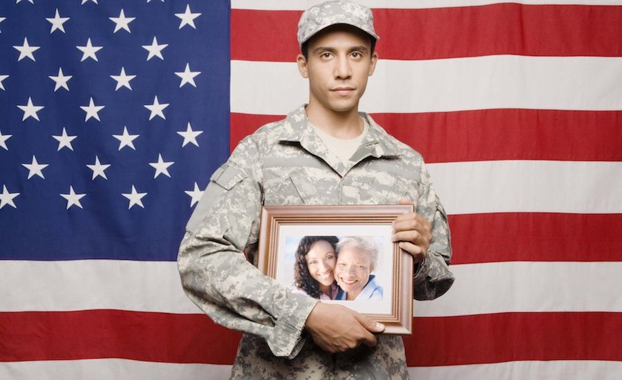 Guideposts: Soldier holding photo of his family.