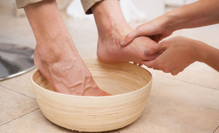 A woman's foot being washed. Photo from 123RF(r).