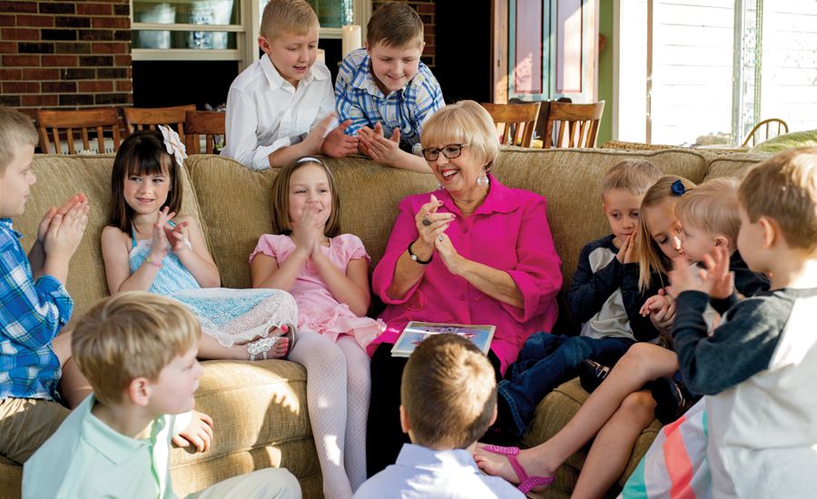 After the Easter egg hunt, Mary Lou delights in leading the grandkids in a song and a story.