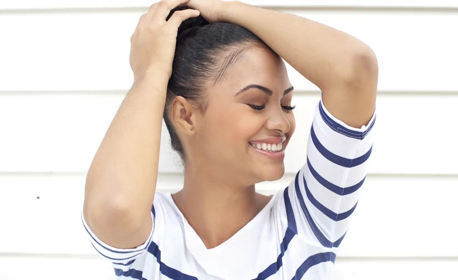 Woman embracing herself smiling