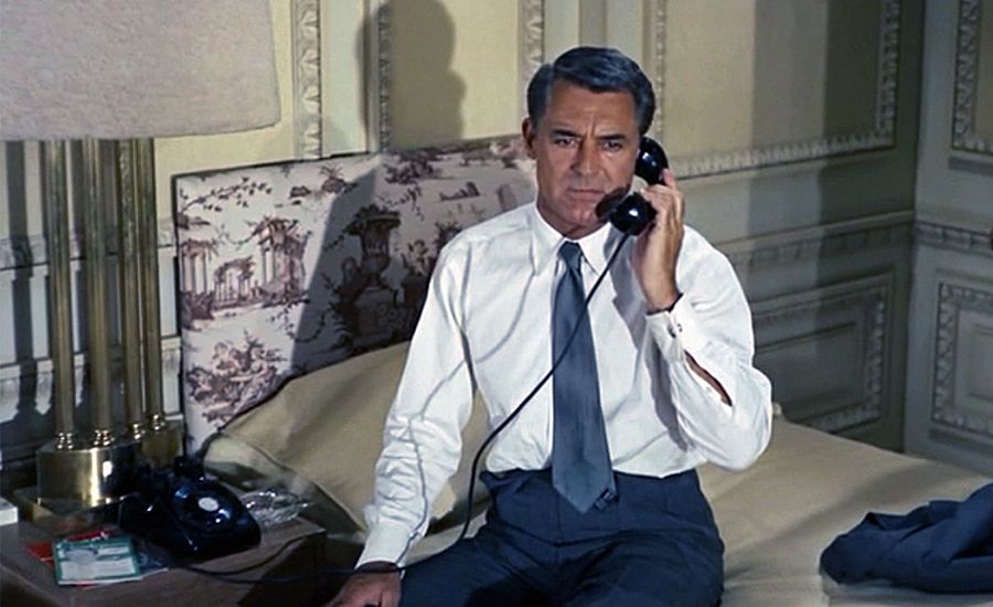 Cary Grant takes a call in a room at NYC's Plaza Hotel