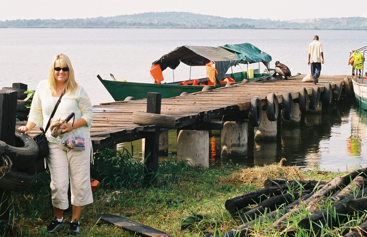 Shelene Bryan waits by a boat dock during her first trip to Uganda in 2003.