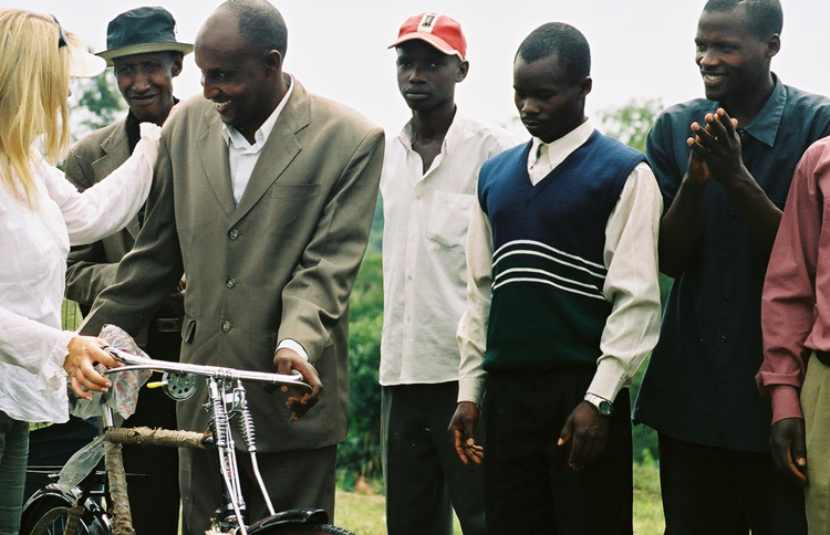 Shelene presents donated bikes to a group of Ugandan pastors.