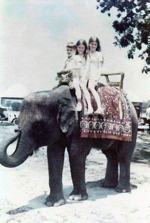 Marcia Jines and her siblings atop an elephant