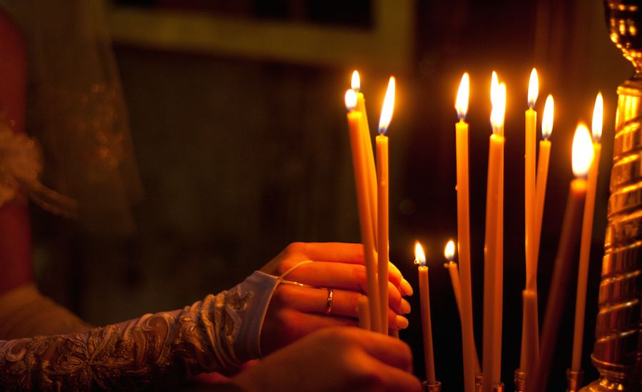 Lighting candles in a church. Photo: Thinkstock.