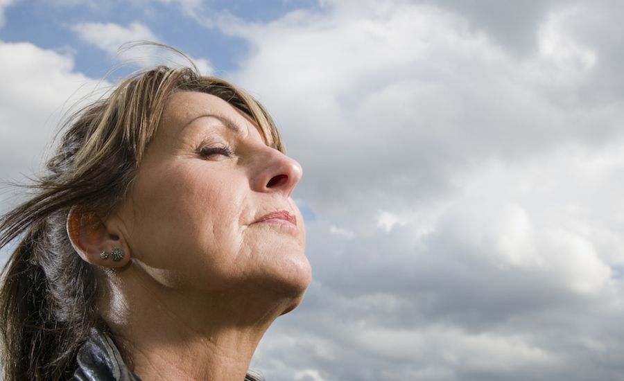 Woman being still, with eyes closed. Thinkstock.