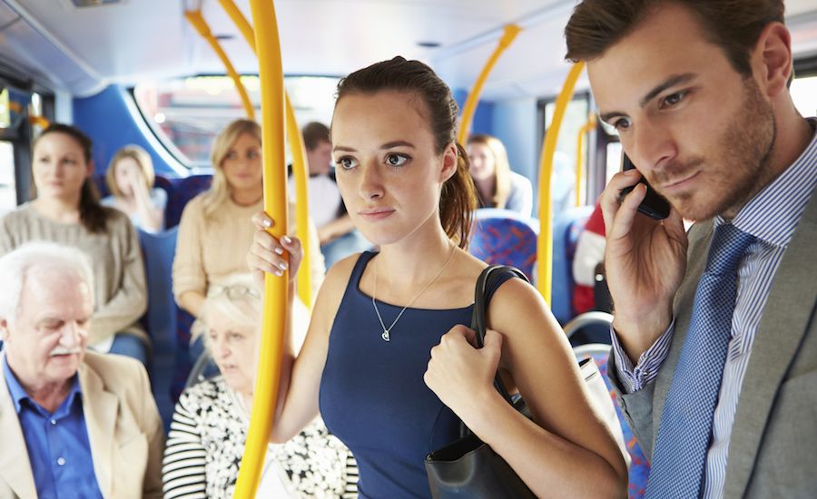 Secretly praying for someone on a bus. Thinkstock.
