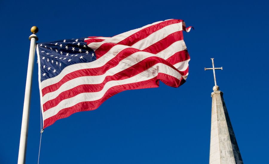 American flag and a church steeple (Thinkstock)