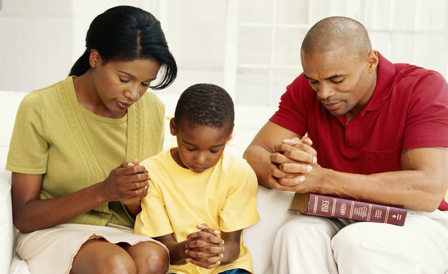A family praying in their home.