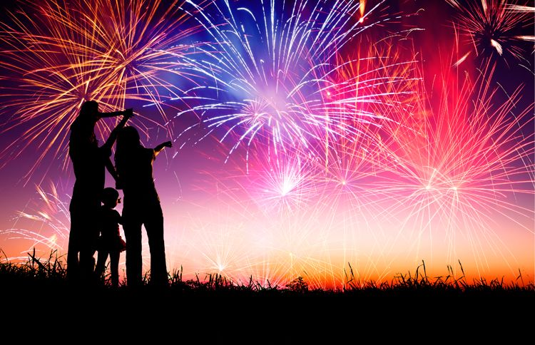 A family watches with delight as an inspiring municipal fireworks display plays before them.