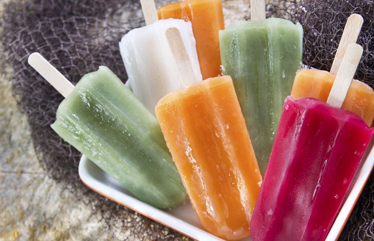 An assortment of refreshing, delicious popsicles in a variety of colors