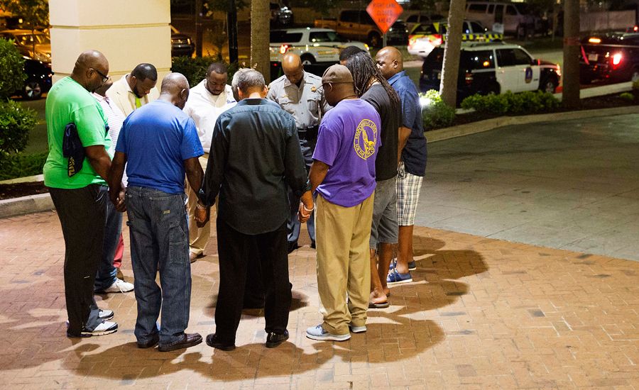Worshippers gather to pray down the street from the Emanuel AME Church in Charleston, S.C.