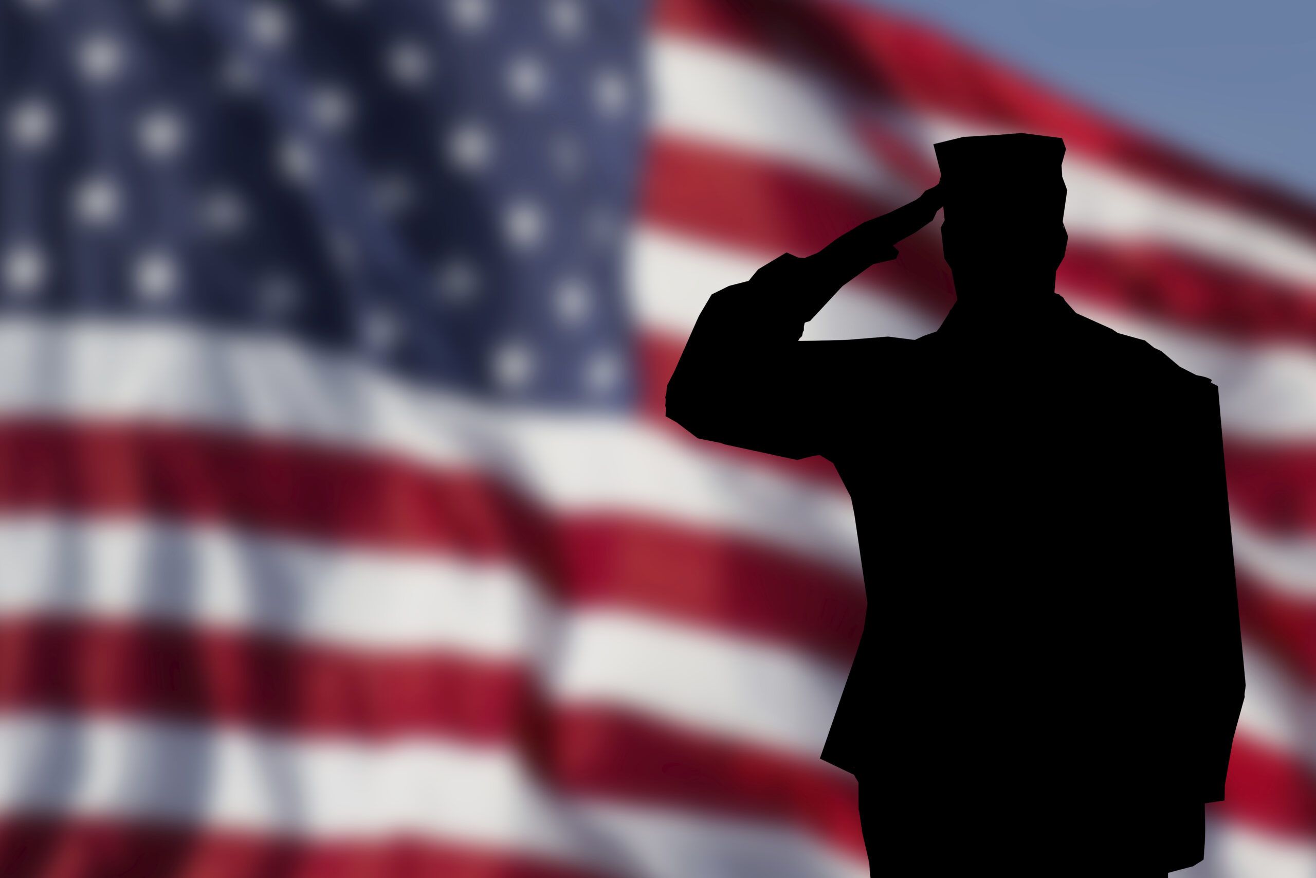 A soldier saluting the American Flag