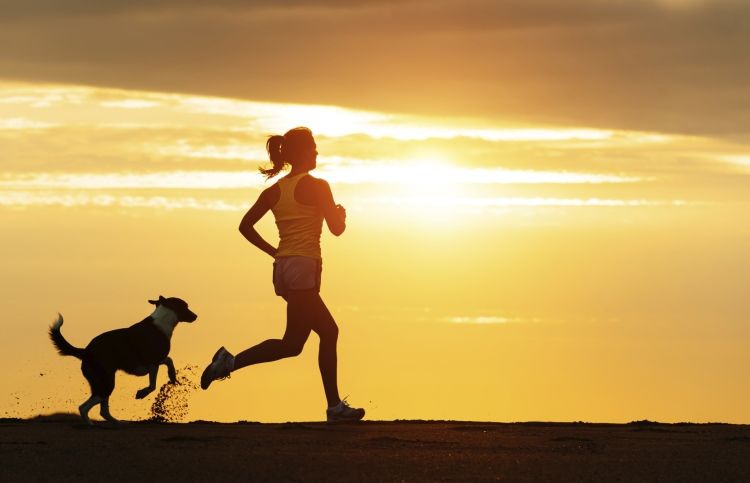Woman running in sunset inspired by Bible verses to reach her goals