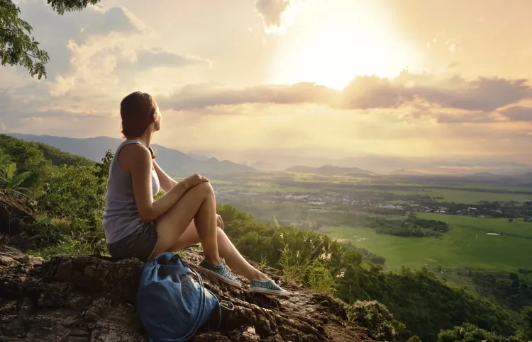 Woman enjoying the sunrise and living her life's dream.