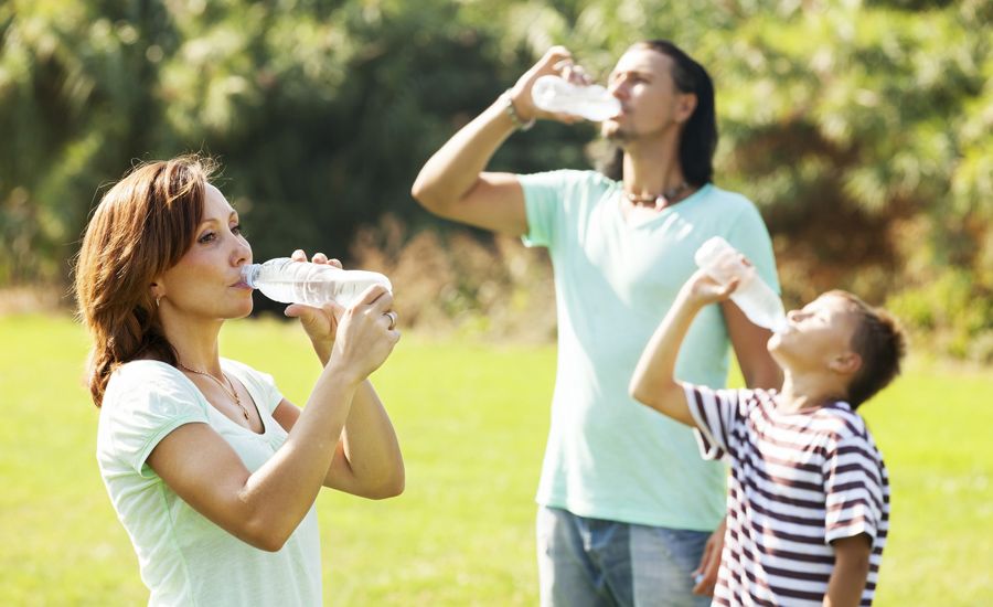 Family drinking water, staying hydrated in the summer