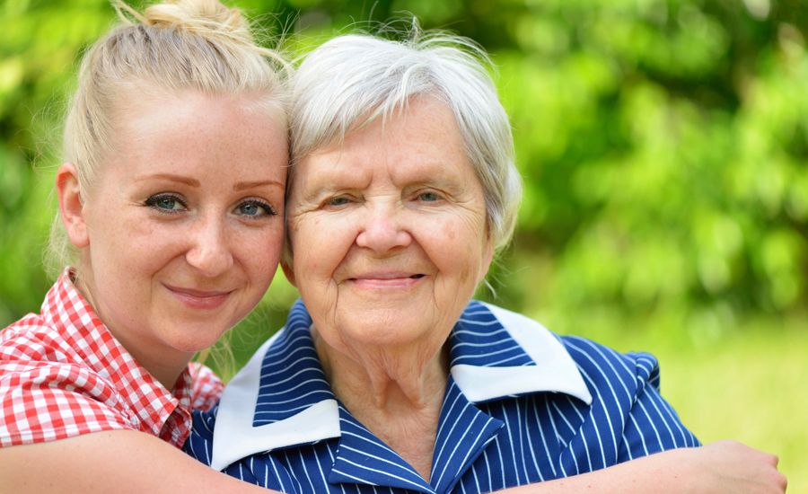 Guideposts: A young woman lovingly embraces her grandmother.