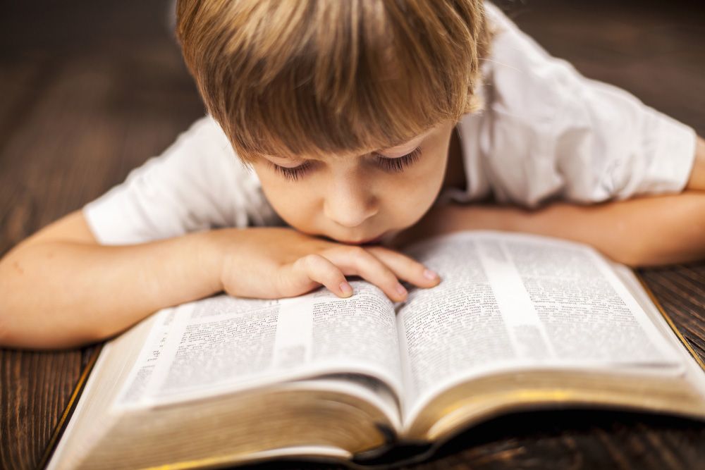 little boy reading the Bible
