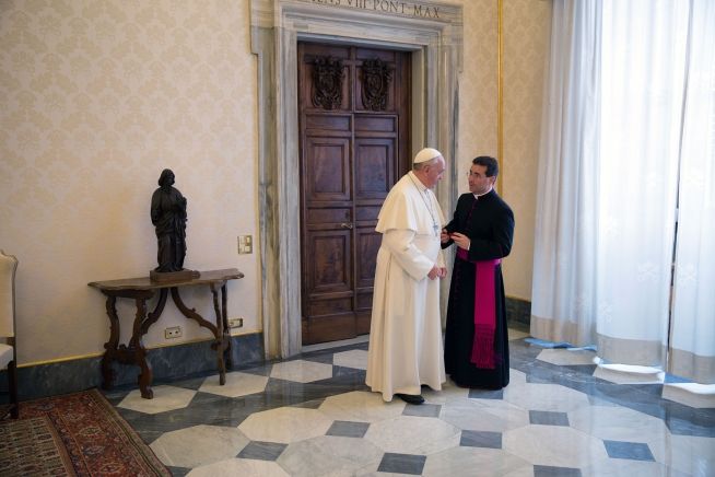 Pope Francis confers with his interpreter follwong a private audience with President Barack Obama in the Vatican