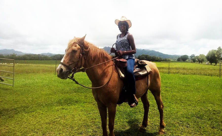Brooke Obie rides the horse Waikoko with Princeville Ranch Adventures in Princeville, Kaua'i