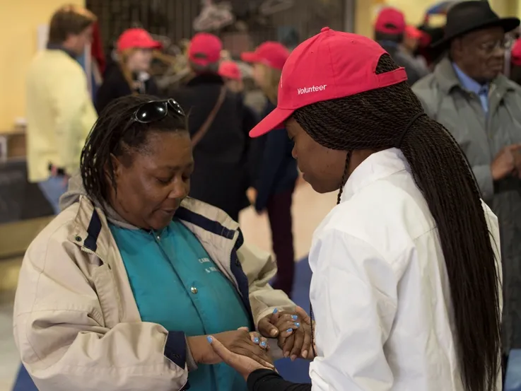 OurPrayer Manager, Ty'Ann Brown prays with another during an OurPrayer Event.