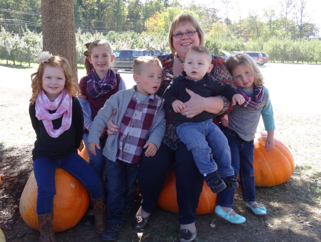Happy grandmother Michelle Cox recently visited an apple orchard with her grandkids.