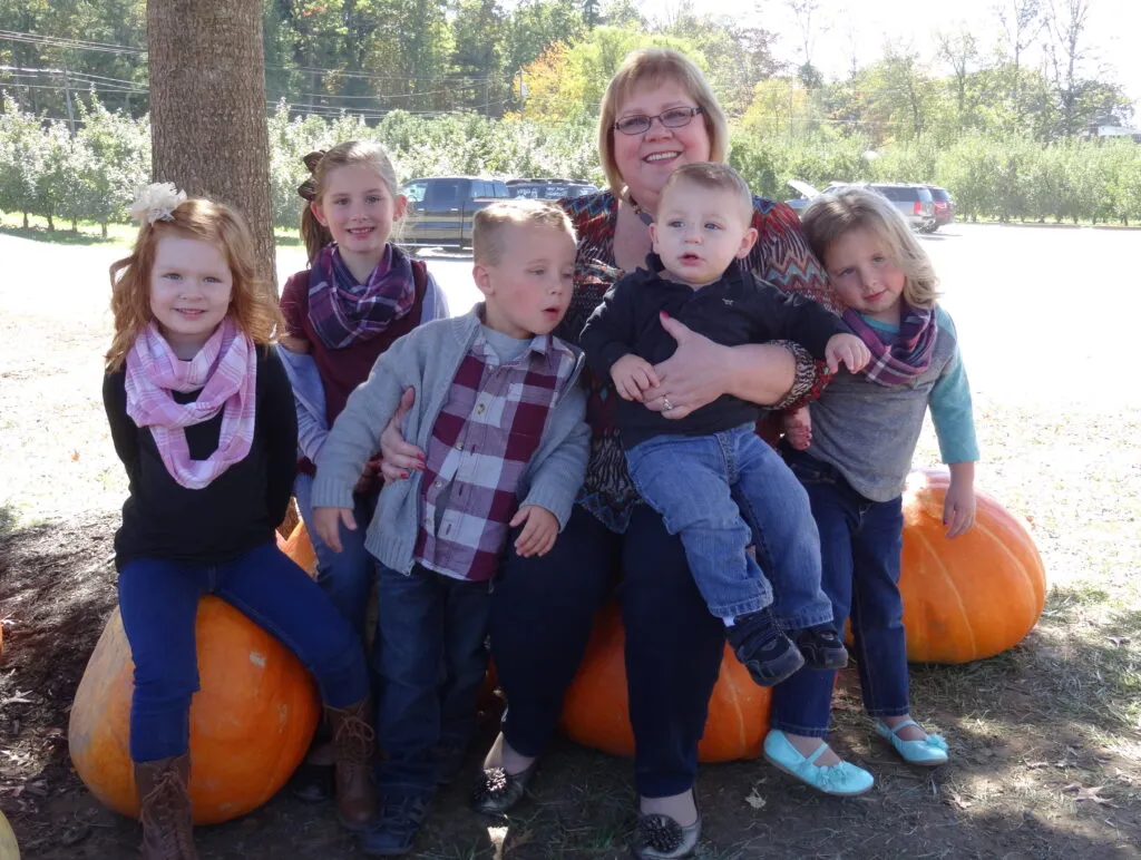 Happy grandmother Michelle Cox recently visited an apple orchard with her grandkids.