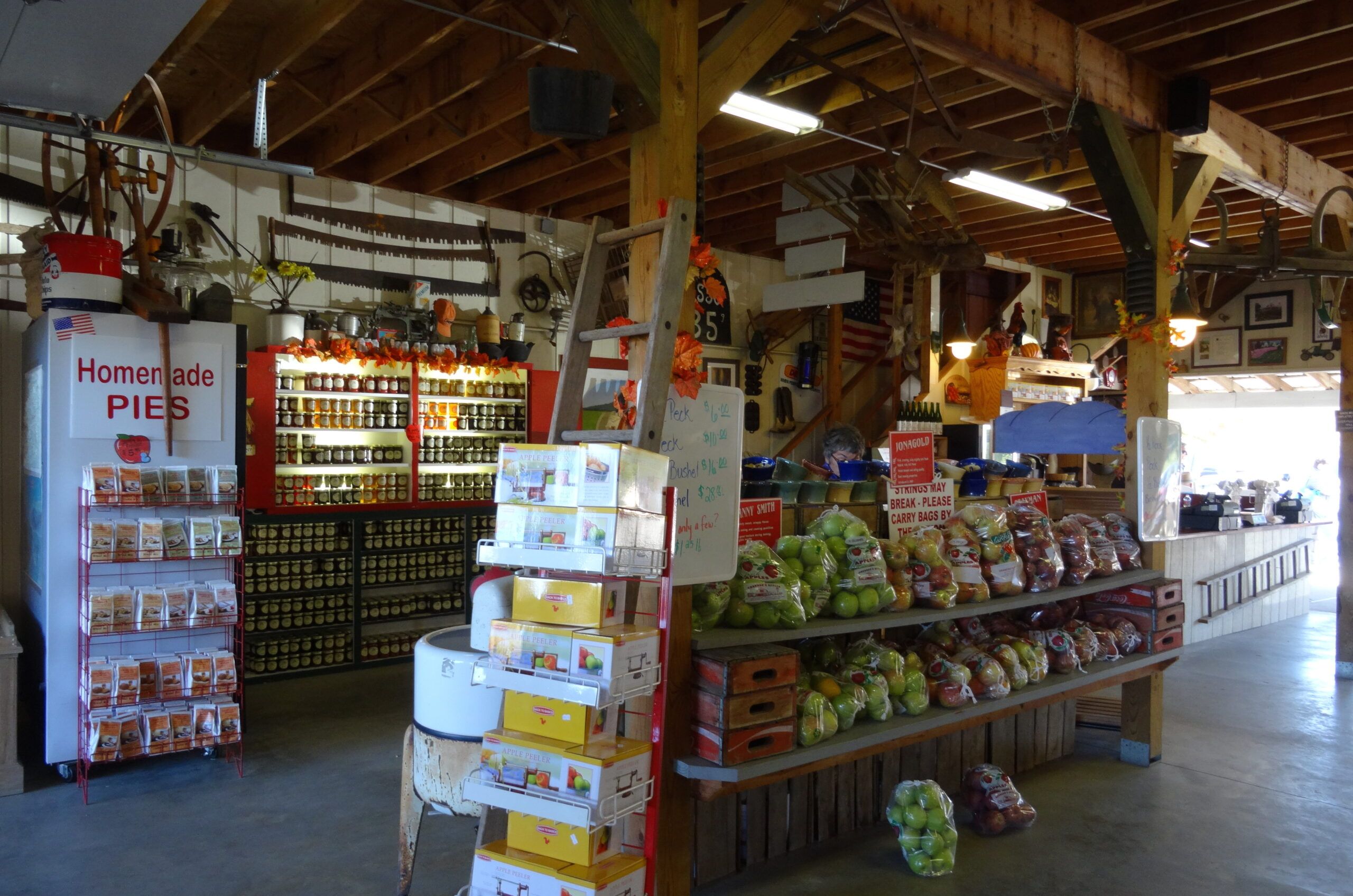 The store at the apple orchard was fully stocked not only with apples but pies, peelers, jams and jellies.