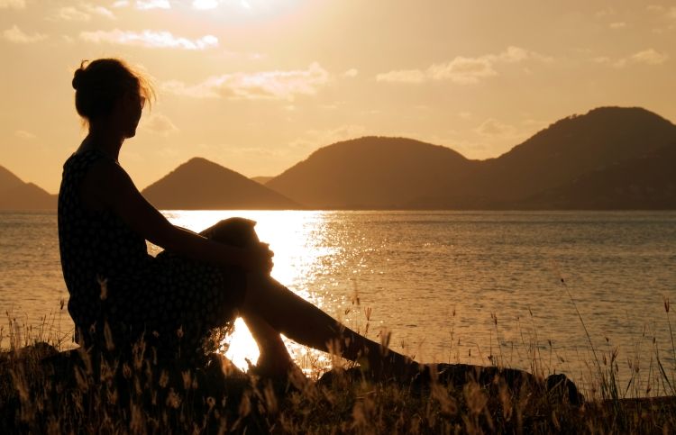 Woman in sunset praying God's promises