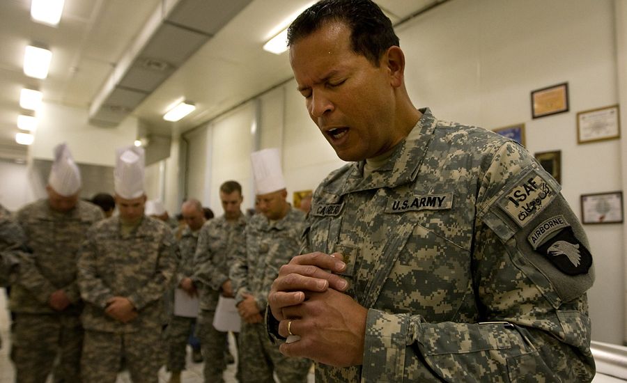 Military Chaplain prays with troops in Afghanistan