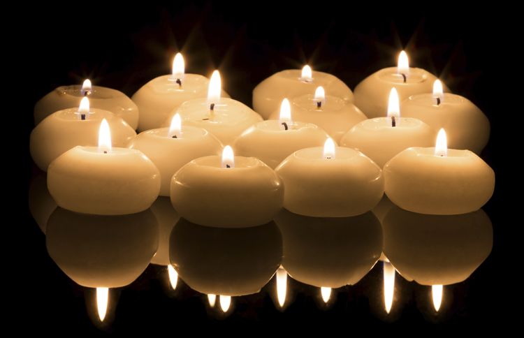 Guideposts: A collection of votive candles create a warm light in the darkness