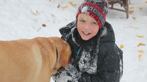 Guideposts blogger Shawnelle Eliasen's son Isaiah and dog Rugby play in the season's first snow.