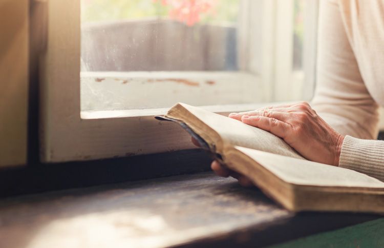 Woman reading Bible with a new year bible verse