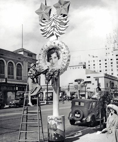 Guideposts: Claudette Colbert admires her oversized portrait lining Vine Street in Hollywood for the 1932 Santa Claus Lane shopping season.