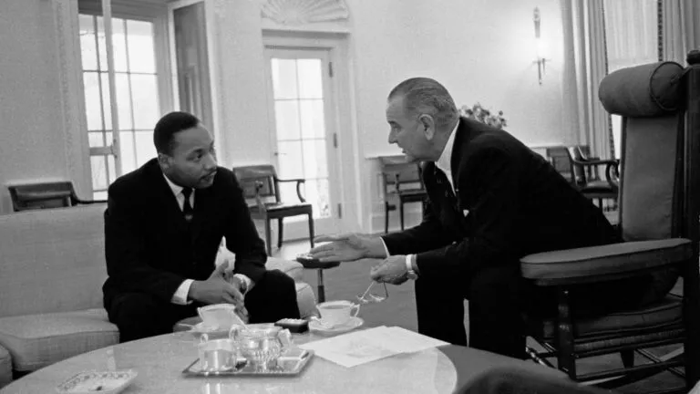 Dr. Martin Luther King Jr saying a prayer with President Lyndon B. Johnson