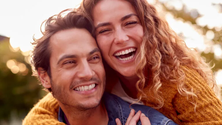 Happy couple smiling together after reading Valentine's Day quotes