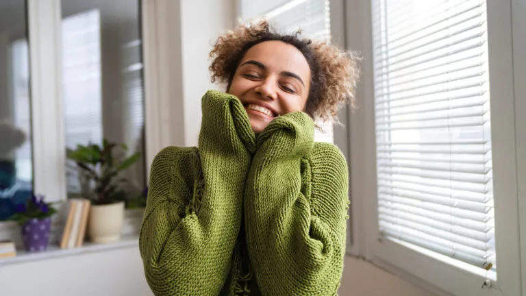 Woman smiling alone after reading Valentine's day quotes