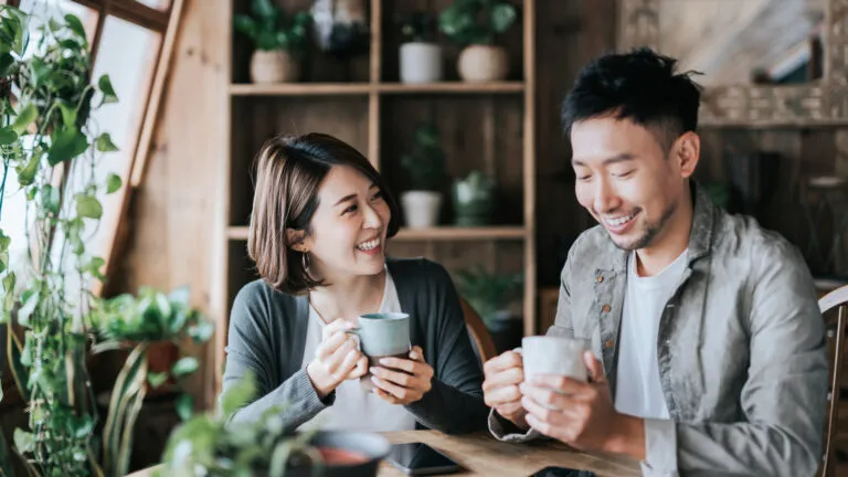 Young couple on a date at a coffee shop discussing Valentine's Day quotes