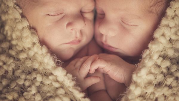 In an amazing video, pre-mature twins are shown holding hands.