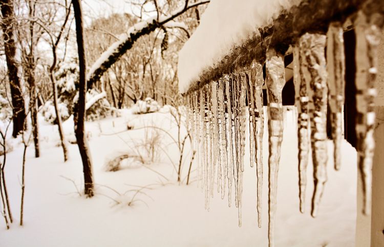 Guideposts: A line of lengthy icicles hang from the eave of a home