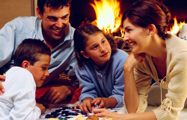Guideposts: A family huddles around a checkers board in front of a roaring fire