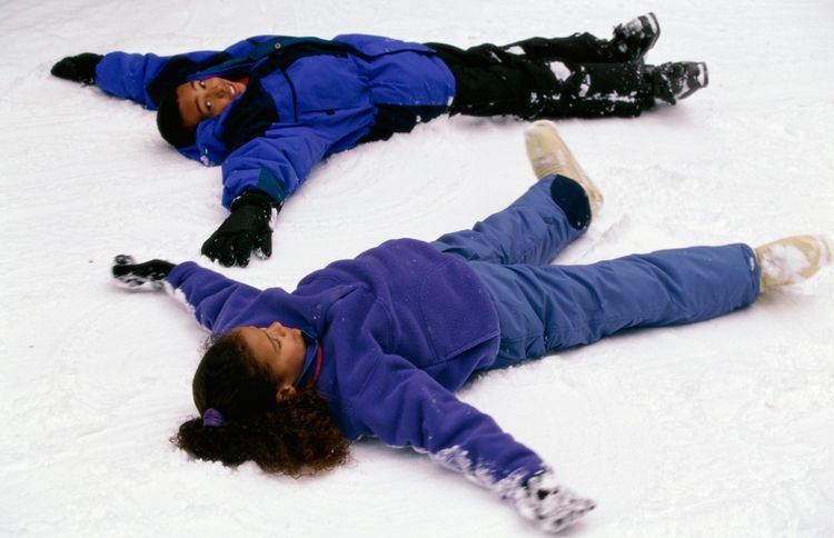 Guideposts: Two children lie in the snow making snow angels