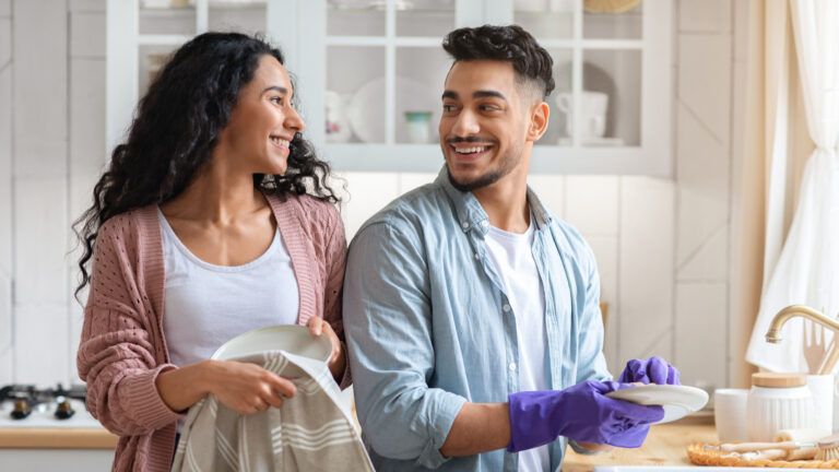 Couple doing the dishes together for their spring cleaning
