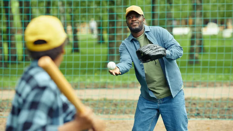 Father and son playing baseball together for their favorite thing about spring